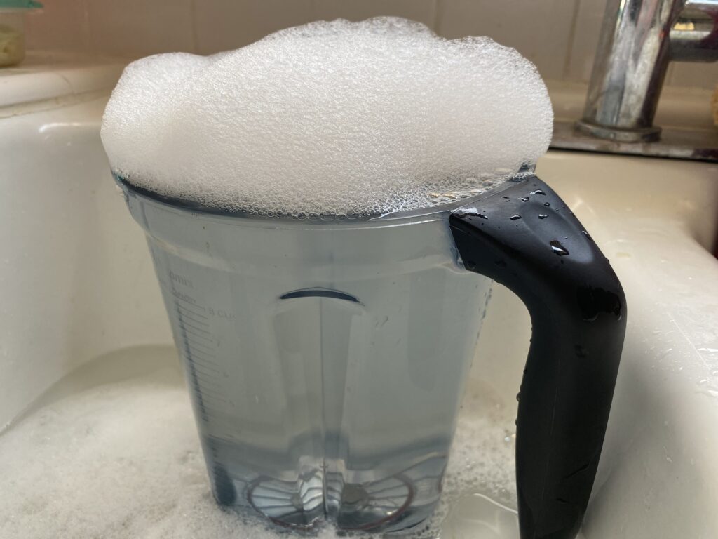 cleaning a Vitamix in sink with bubbles