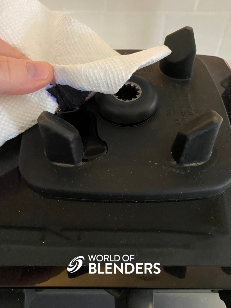 cleaning up a black liquid leak from the blender