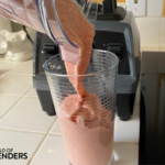 pouring a smoothie into a glass