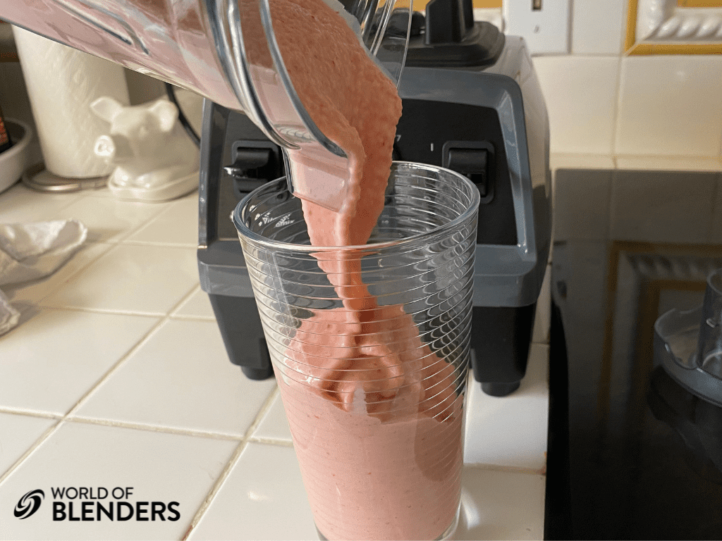 pouring a creamy smoothie into a glass, not foamy