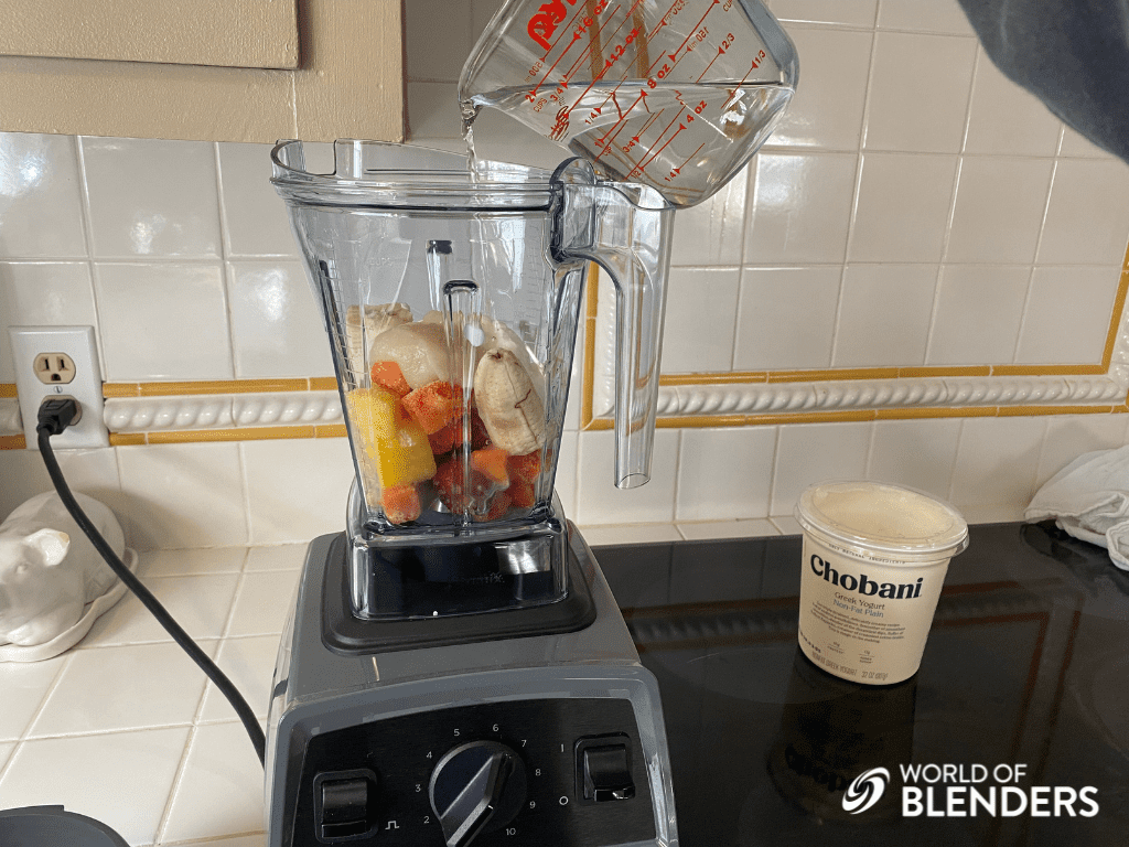 pouring water into blender