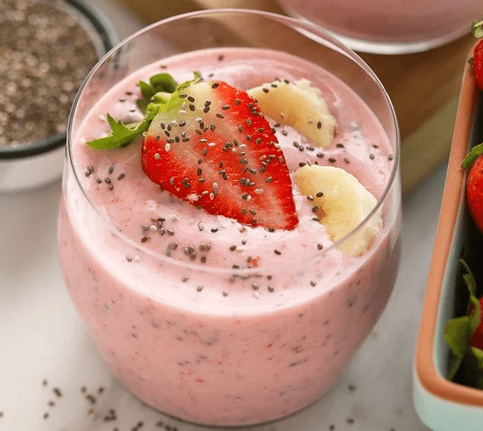 strawberry chia seed smoothie topped with strawberries and banana slices