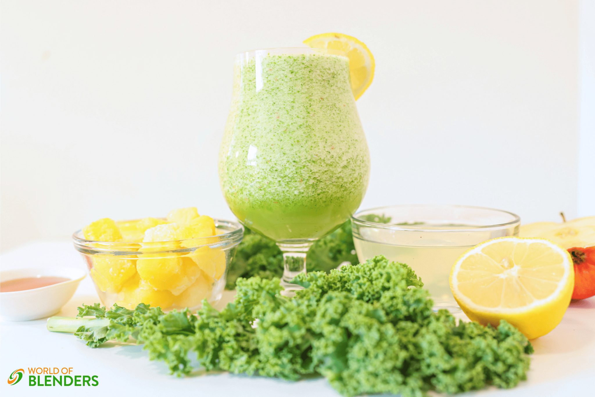 kale apple smoothie in a glass with kale and fruit around it