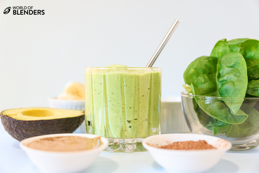 spinach avocado smoothie with ingredients around it