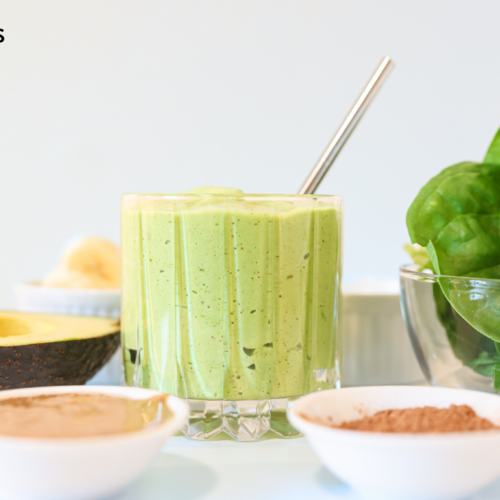spinach avocado smoothie with ingredients around it