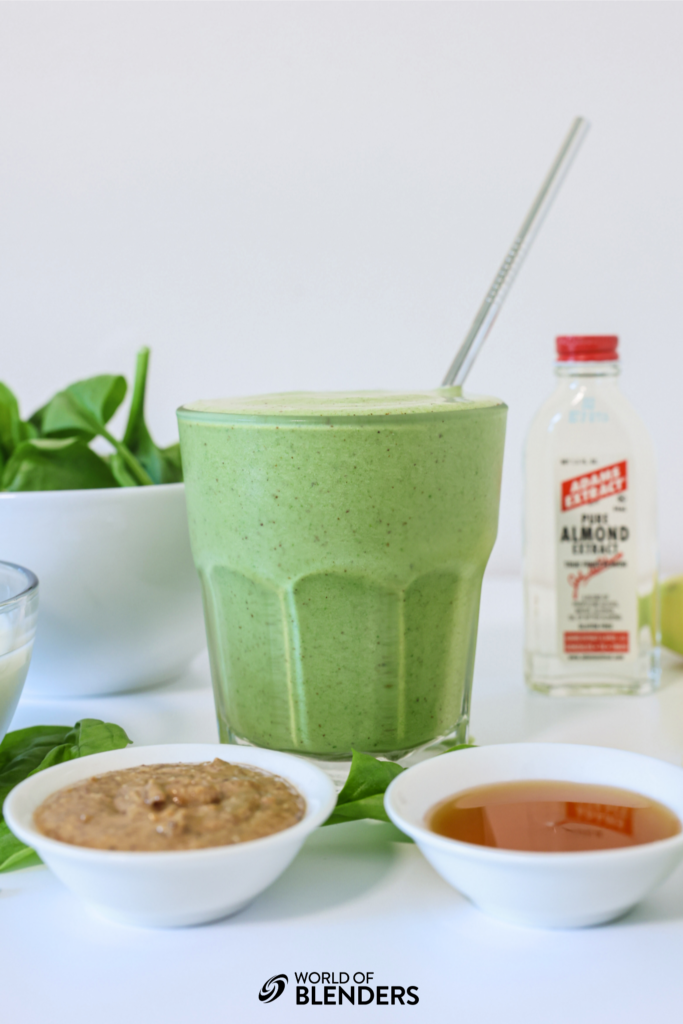 spinach banana smoothie in a glass with ingredients around it